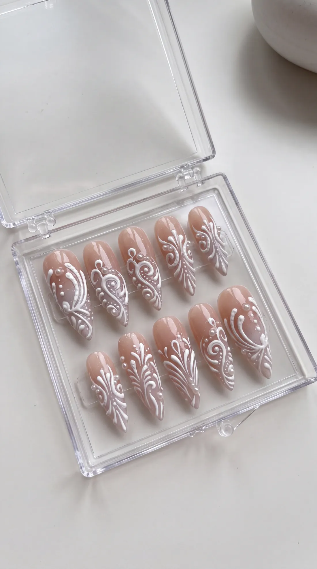 Burning White press-on nails in their case