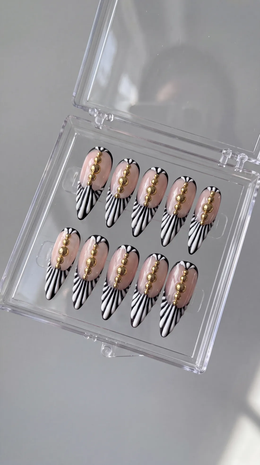 Clocked Out press-on nails in their case