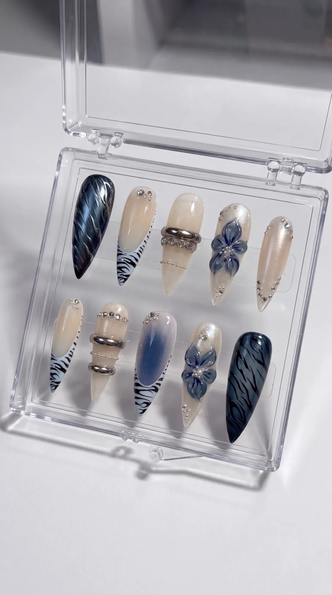 Midnight Bloom press-on nails in their case