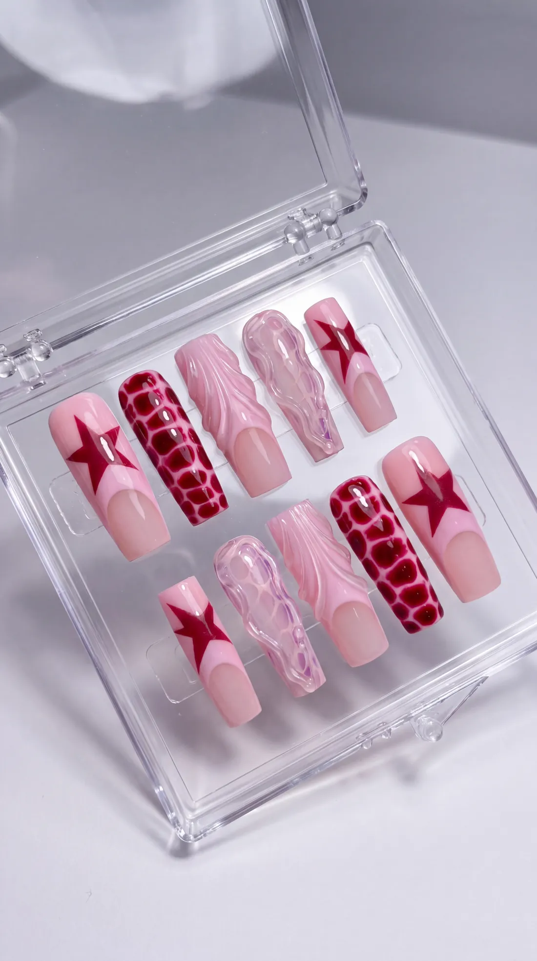 Wonderland press-on nails in their case